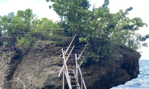 Our 2-Day Itinerary in Limasawsa, Southern Leyte, Philippines featuring this large rock with wooden stairs in Island Lagoon Resort